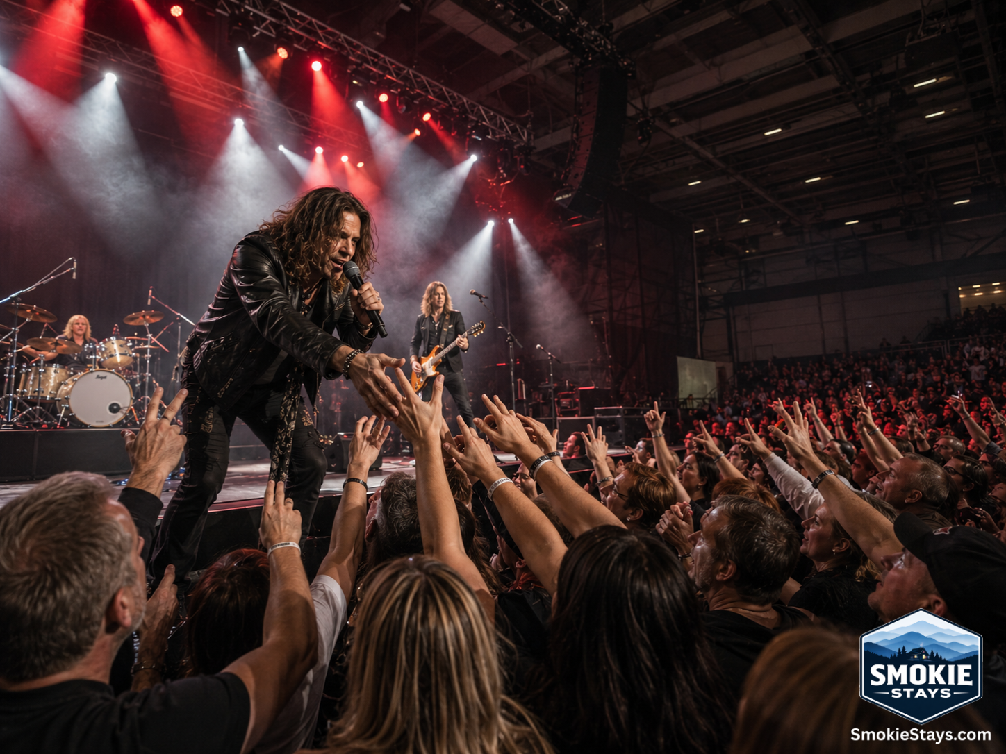 A classic rock performer takes the stage under dramatic spotlights at The Mountain Music Festival inside the Gatlinburg Convention Center, with an energized crowd filling the venue floor.
