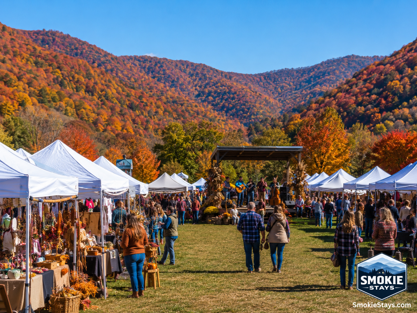 Craft vendor tents fill a wide open field at the Wears Valley Fall Fest, with visitors browsing handmade goods and vibrant fall foliage covering the surrounding mountain ridgelines under a clear October sky.